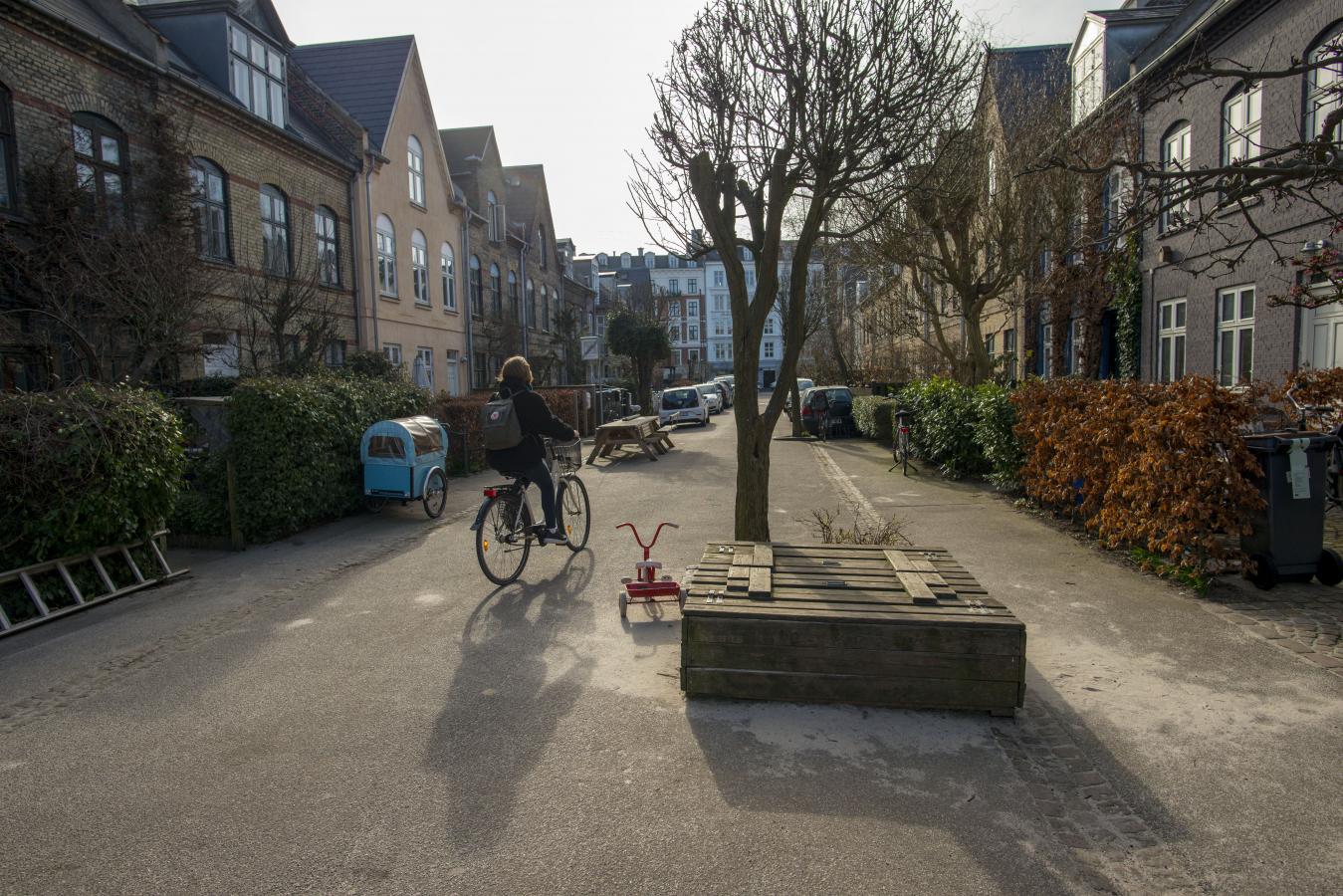 Narrowed lanes and planter boxes calm traffic by design.