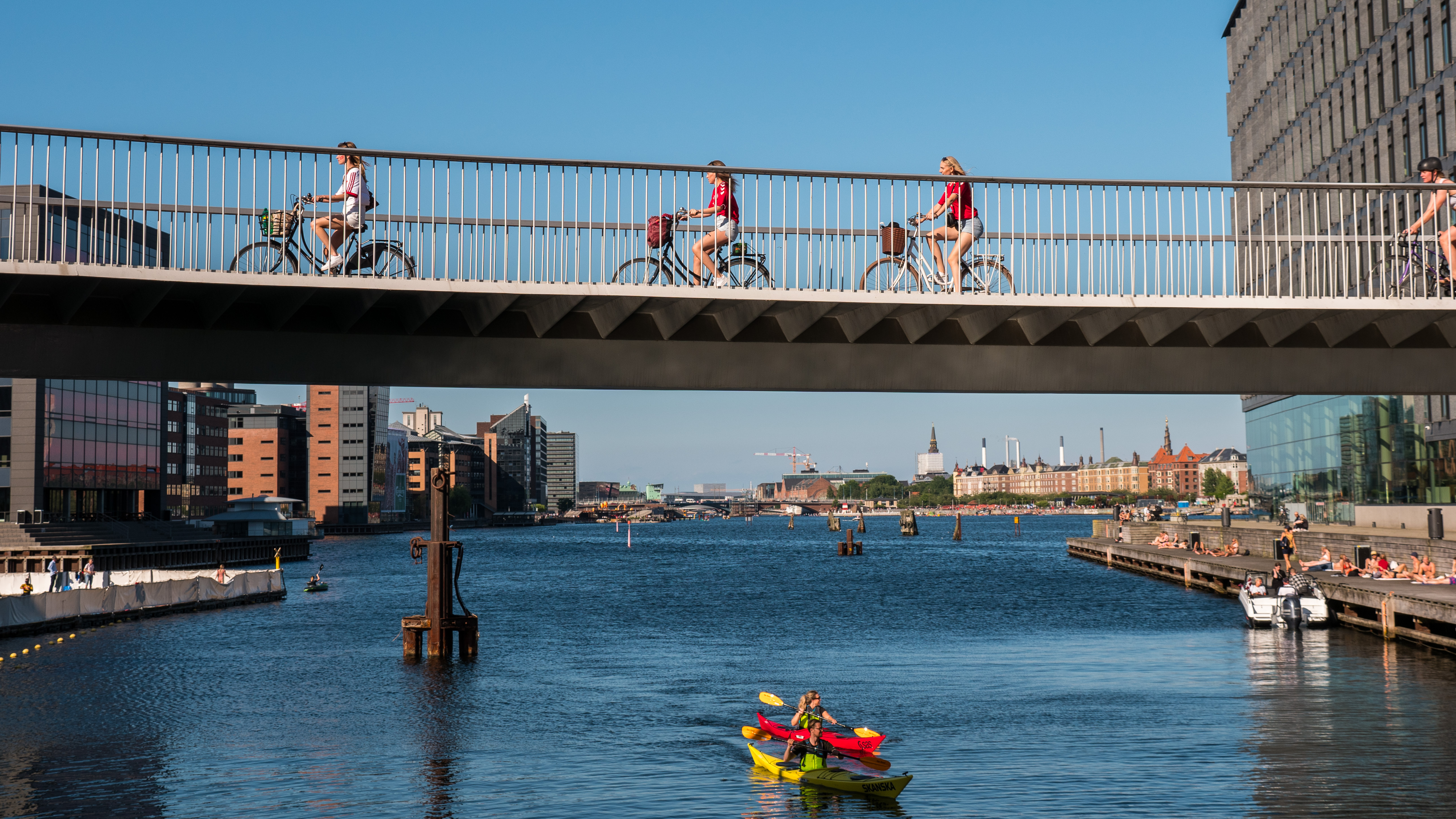 people riding a bike on a bridge