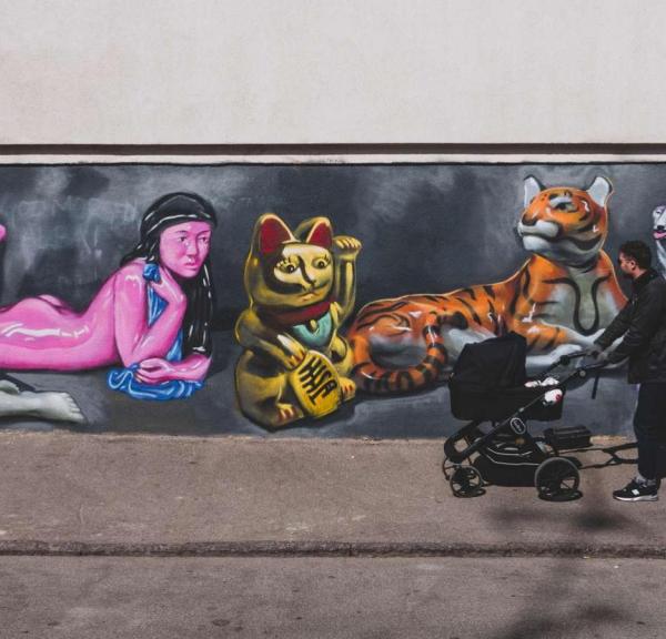 A father walking a stroller in the streets of Vesterbro, Copenhagen.