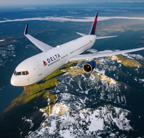 Delta airplane flying over earth