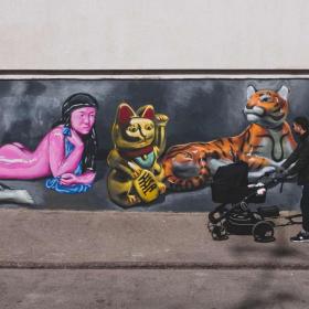 A father walking a stroller in the streets of Vesterbro, Copenhagen.